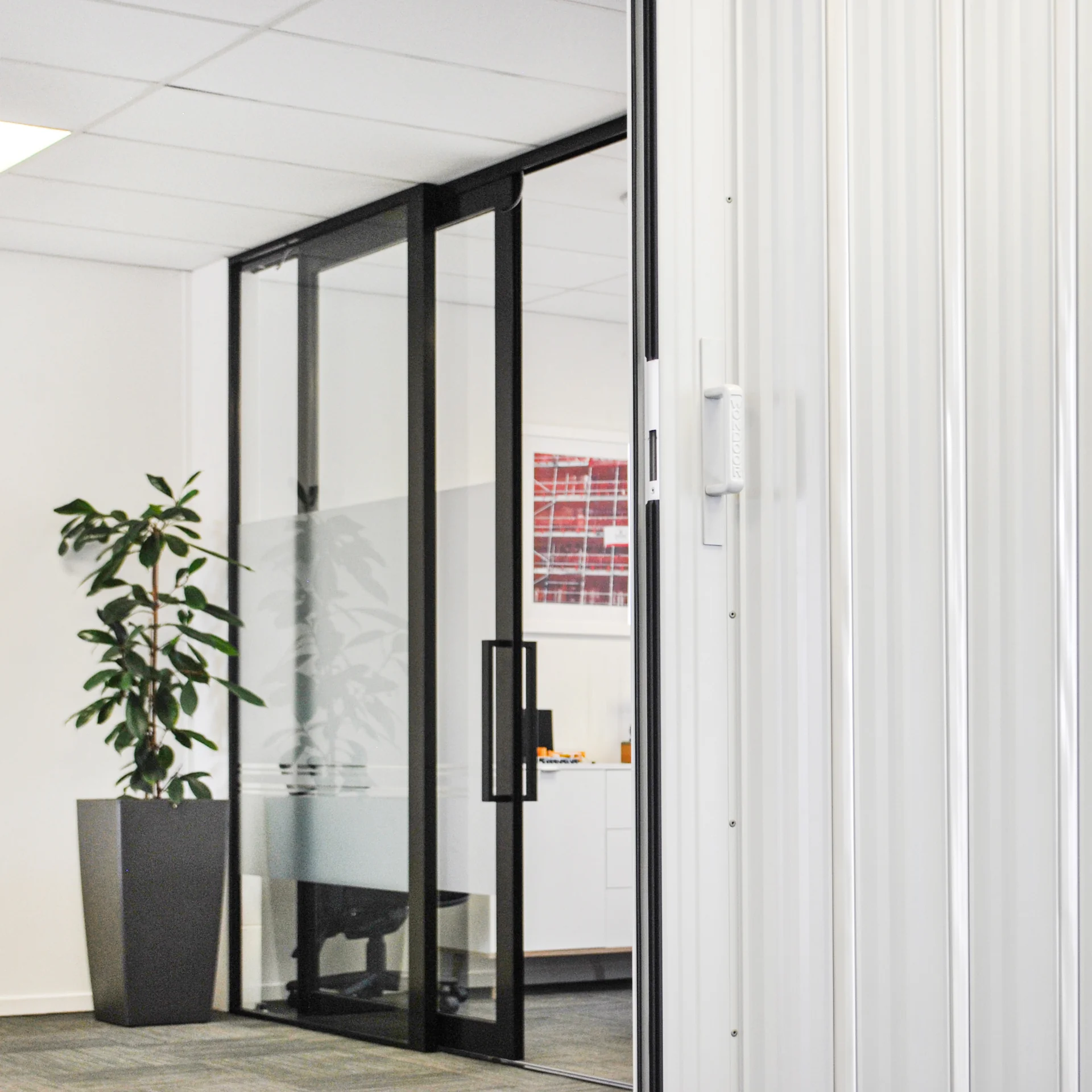 DuraSound acoustic concertina door dividing an office space