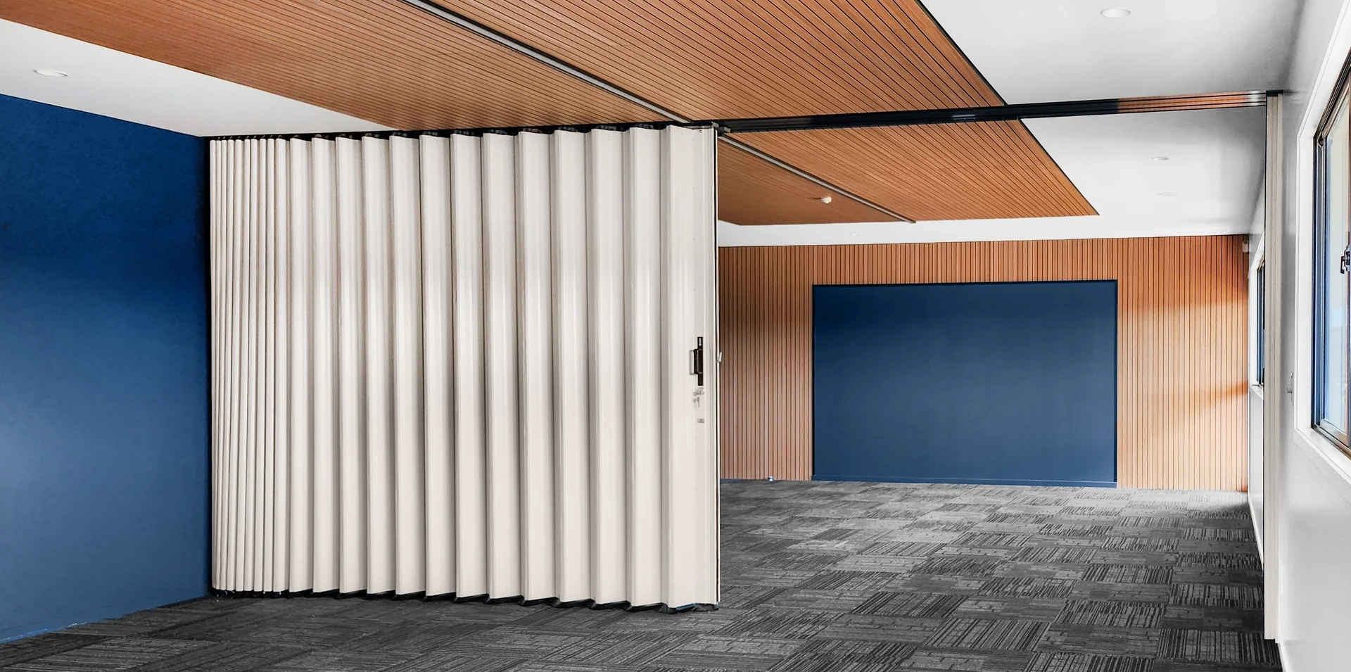 DuraFlex accordion partition dividing a meeting room to create flexible workspace areas
